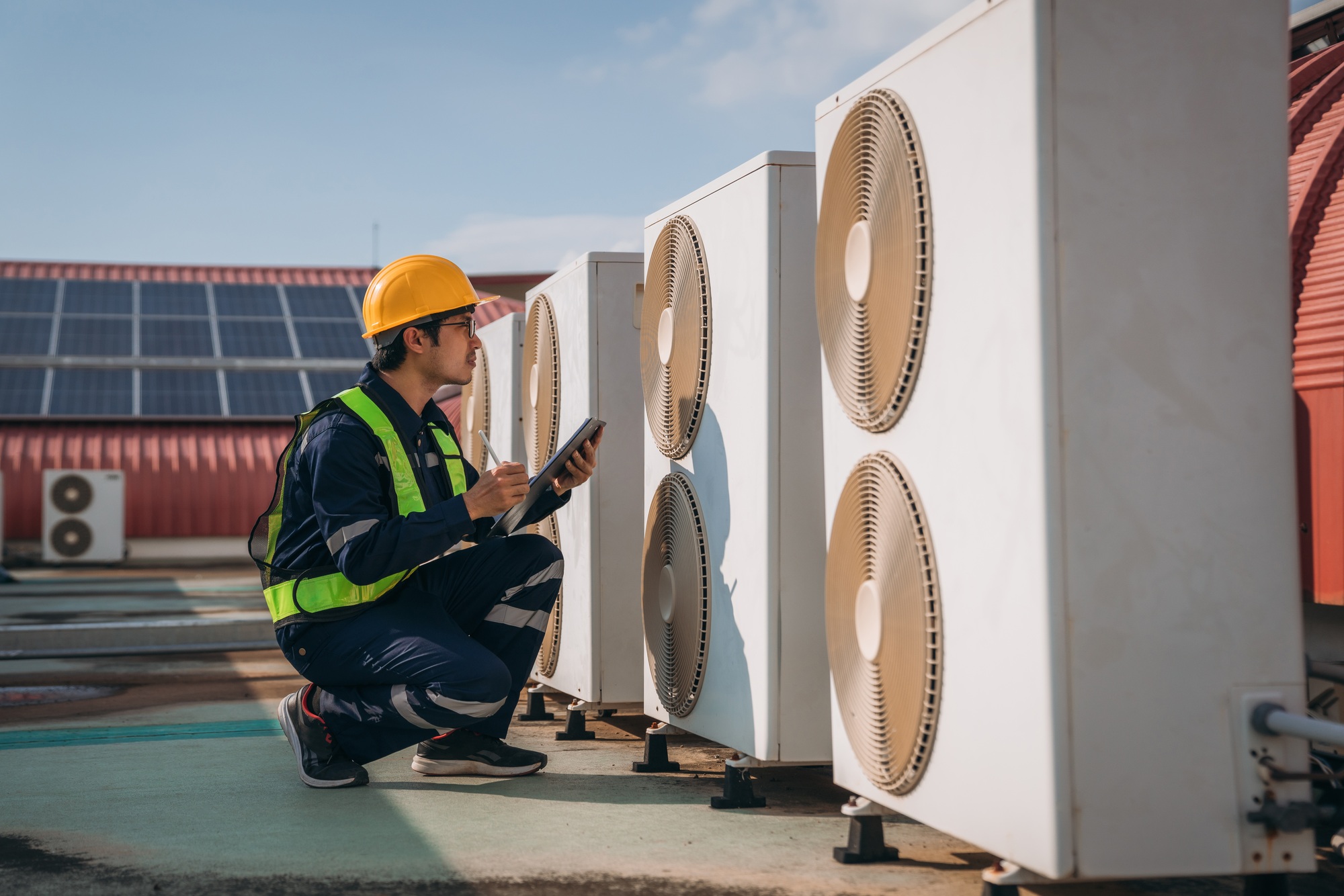 Engineers is checking the air conditioning cooling system of a major building.