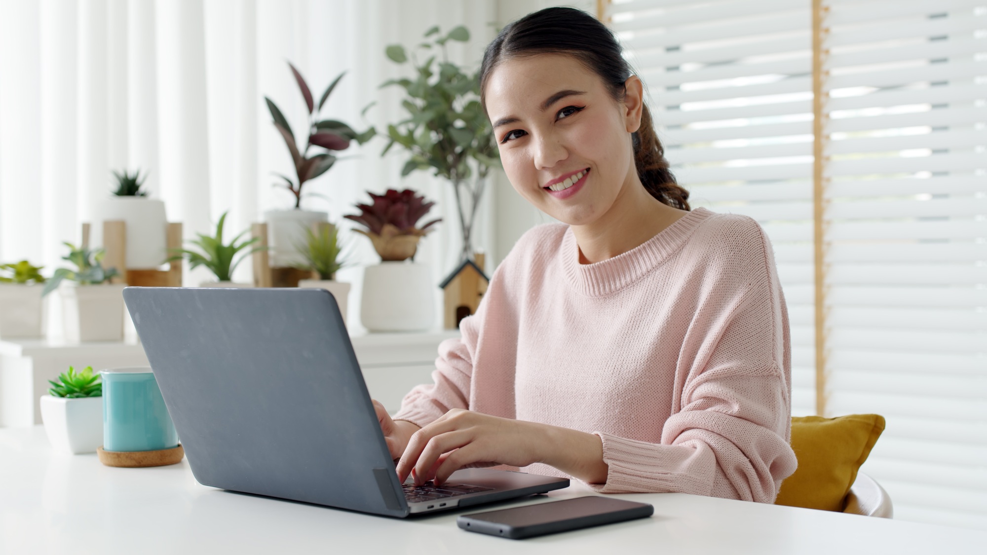 Portrait headshot young attractive beautiful asia female sit on desk smile to camera